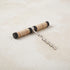 Pull-style corkscrew with a black mango wood and natural rattan wrapped handle and a stainless steel worm
