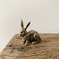 The Vigilant Seeker miniature brass rabbit with detailed fur texture and golden patina against a neutral background
