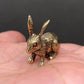 The Vigilant Seeker miniature brass rabbit held in hand to show scale, with upright ears and warm aged patina, from the WILLAGE Tiny Objects collection
