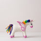 Hand-felted white unicorn with a rainbow mane and tail, pink muzzle and hooves, and felt wings, on a white background