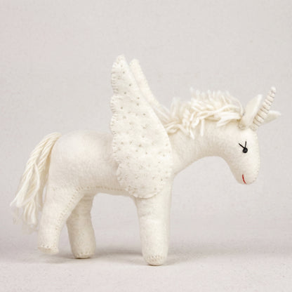 All-white hand-felted unicorn with beaded wings, a floss mane and spiralled horn, on a white background