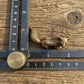 The Watchful Spirit miniature brass fox showing side profile with golden patina against a neutral background
