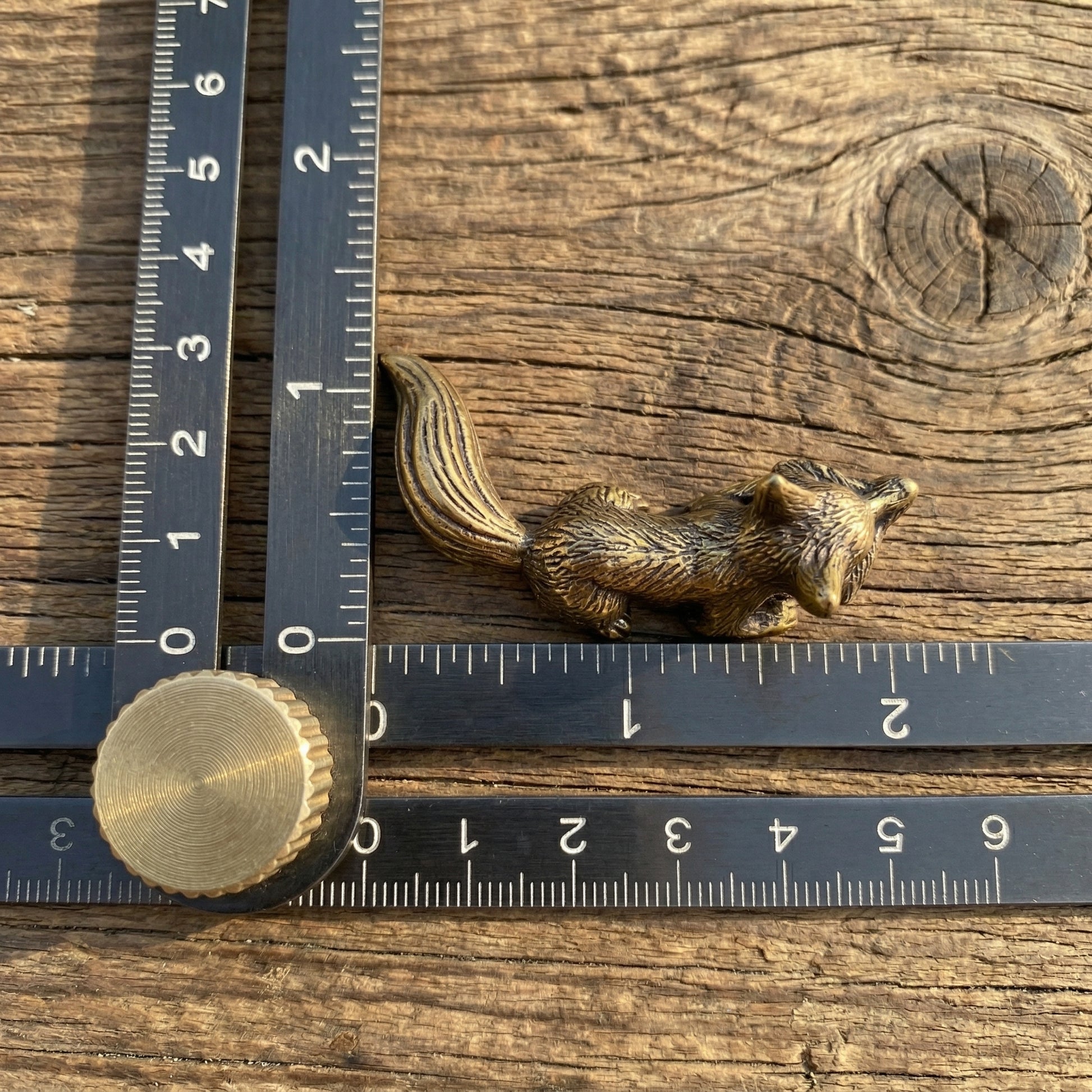 The Watchful Spirit miniature brass fox showing side profile with golden patina against a neutral background
