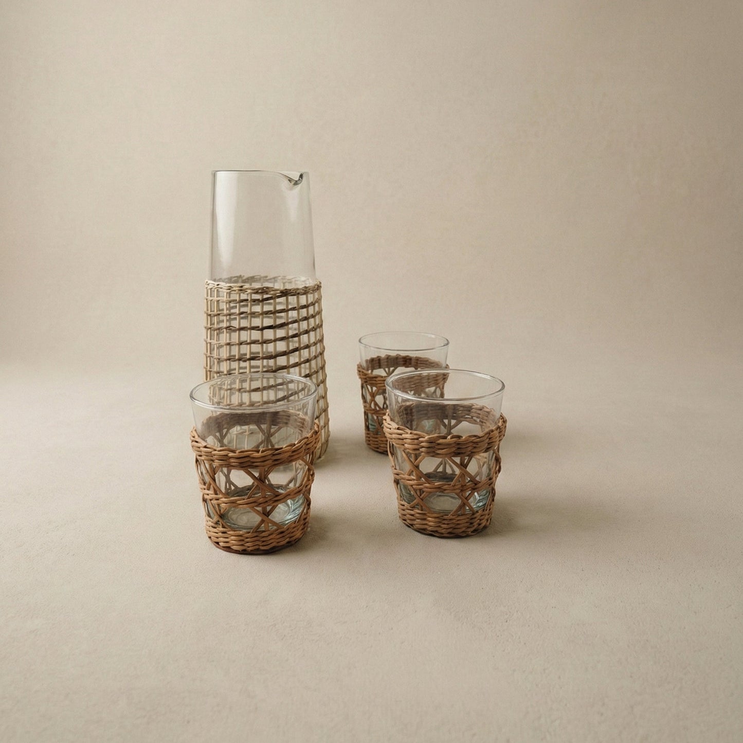 The Weaver's Carafe close-up showing cane weaving texture wrapped around clear recycled glass