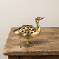 The Wild Goose brass incense burner held in a hand to show its size, about 3.5 inches long