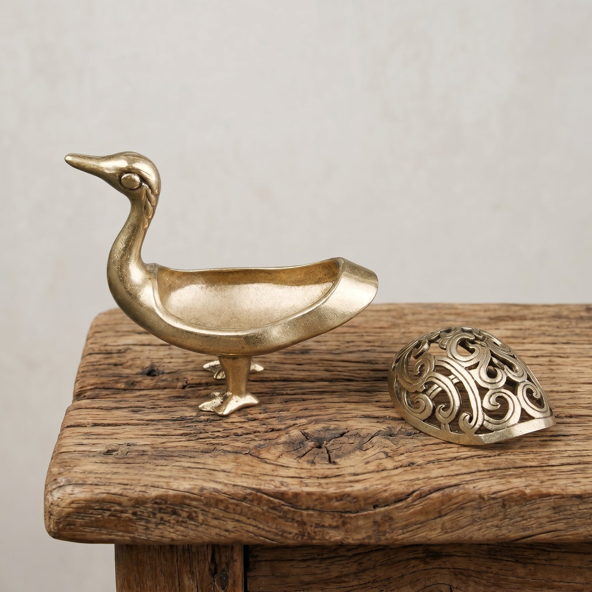 The Wild Goose brass incense burner with an intricate pierced openwork lid, antique gold finish
