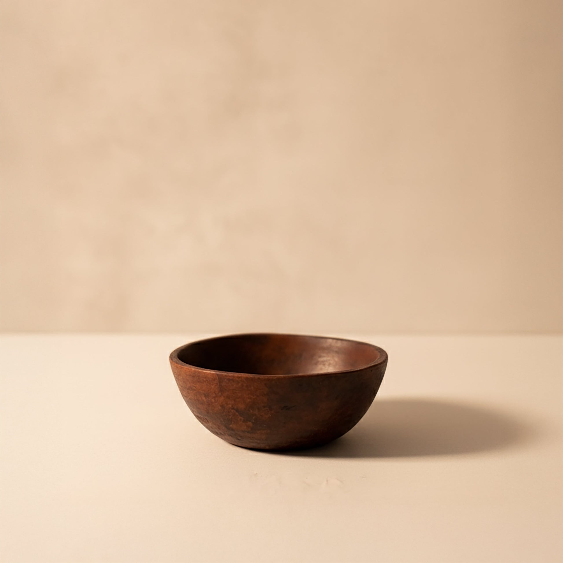 Brown ceramic bowl on a beige background