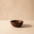 Brown ceramic bowl on a beige background
