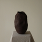 Earth-toned ceramic object with textured surface, handmade and unglazed
