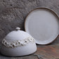 Lunar-style ceramic butter dish in grey crater finish.