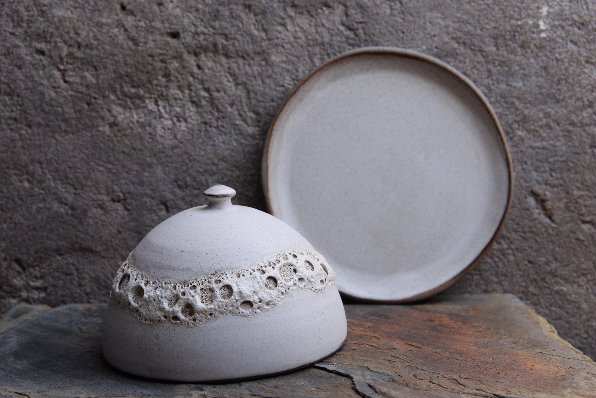 Lunar-style ceramic butter dish in grey crater finish.