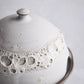 Small ceramic dish for butter or cheese, handmade with crater texture.