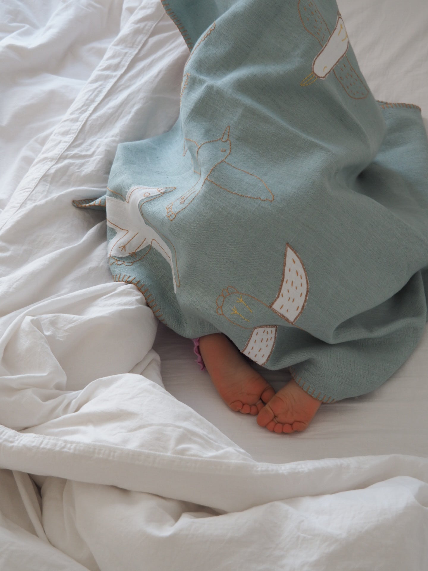 Handwoven organic linen baby blanket dyed with natural plant-based pigments.