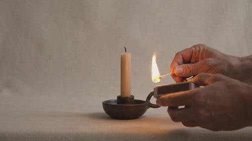 Lighting candle in an earthy candle holder _ willage 