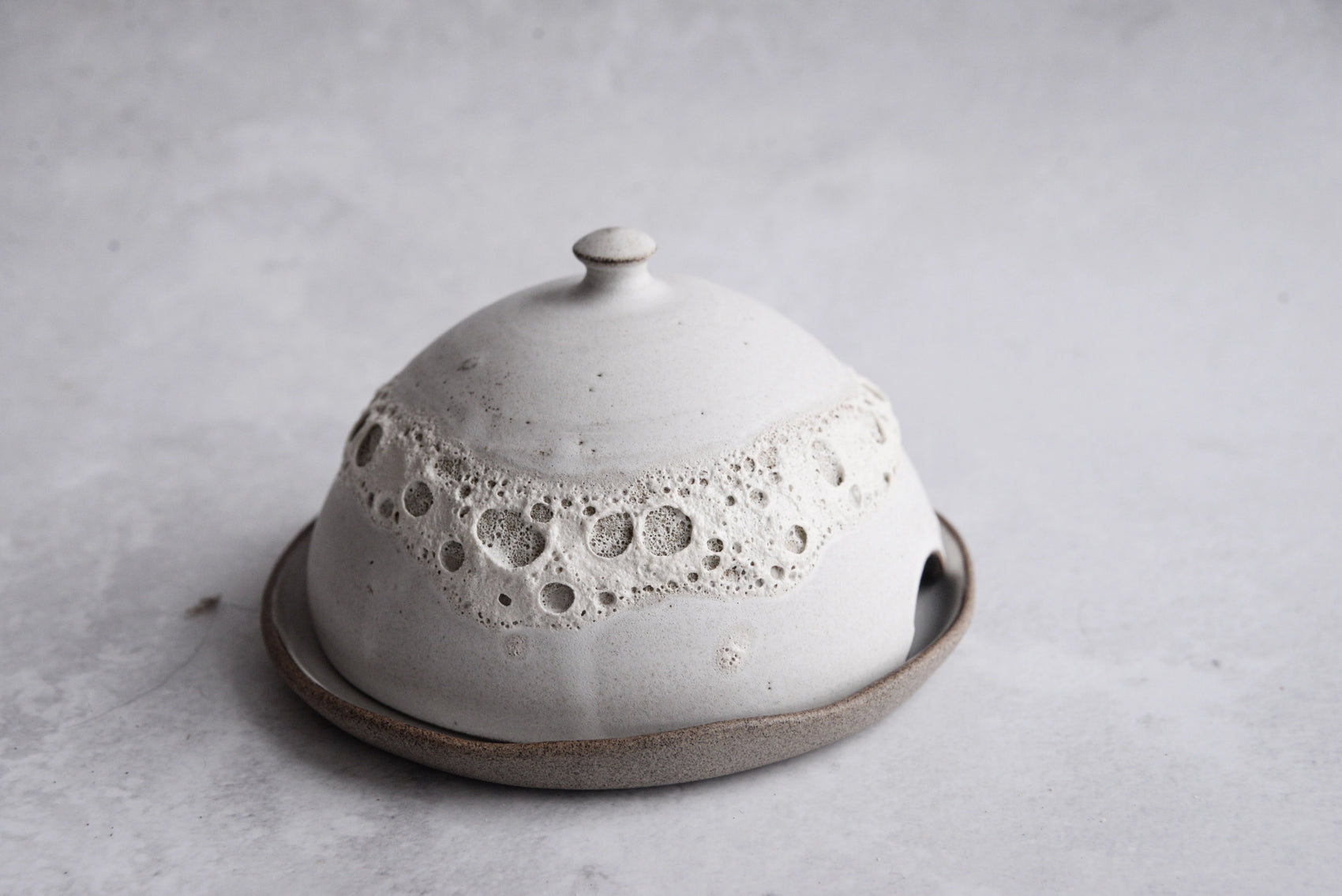 Handcrafted stoneware butter dish with crater glaze inspired by the moon
