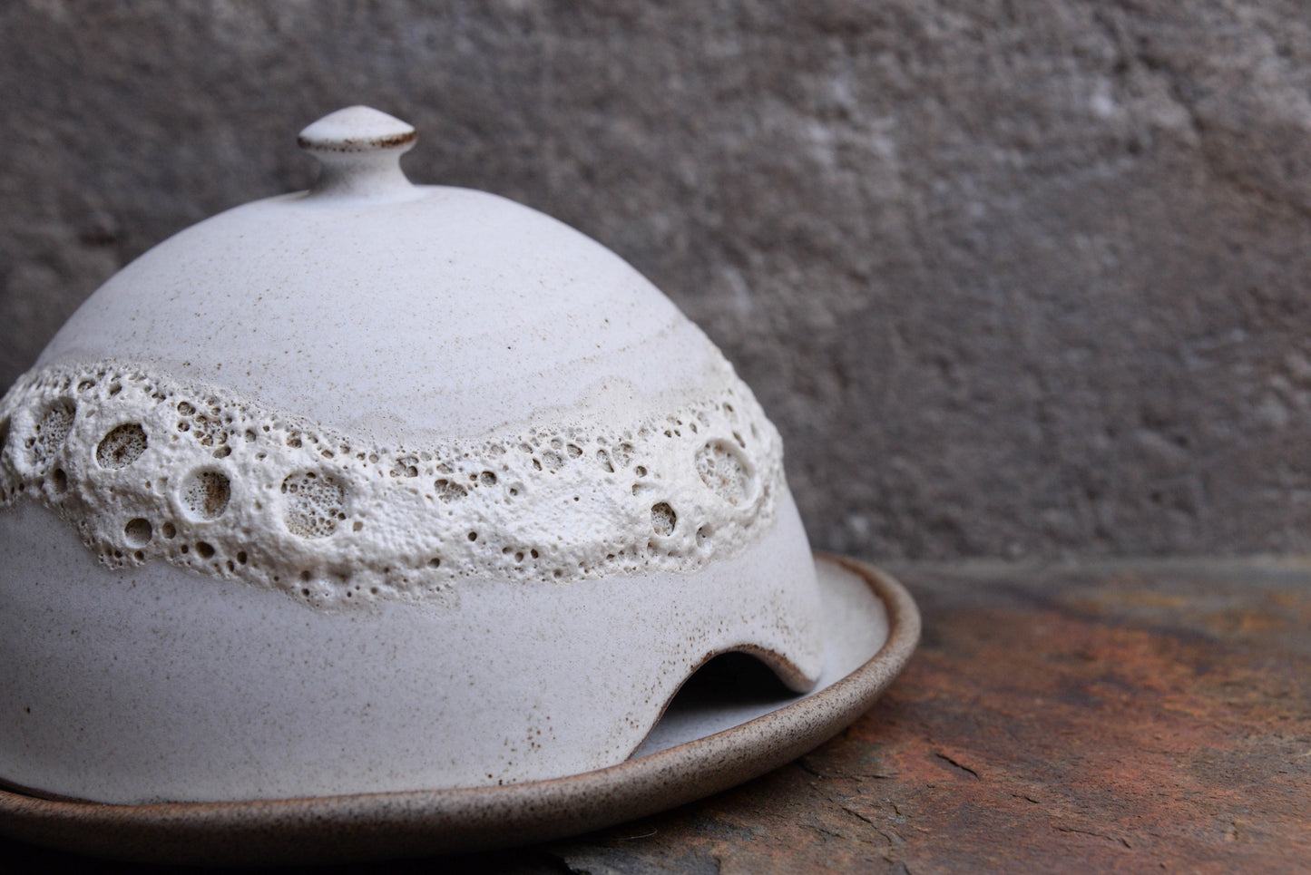 Handcrafted stoneware butter dish with crater glaze inspired by the moon.