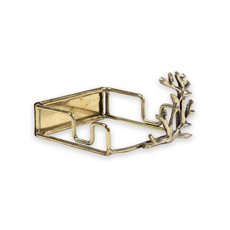 Gold metal napkin holder with coral design on a white background