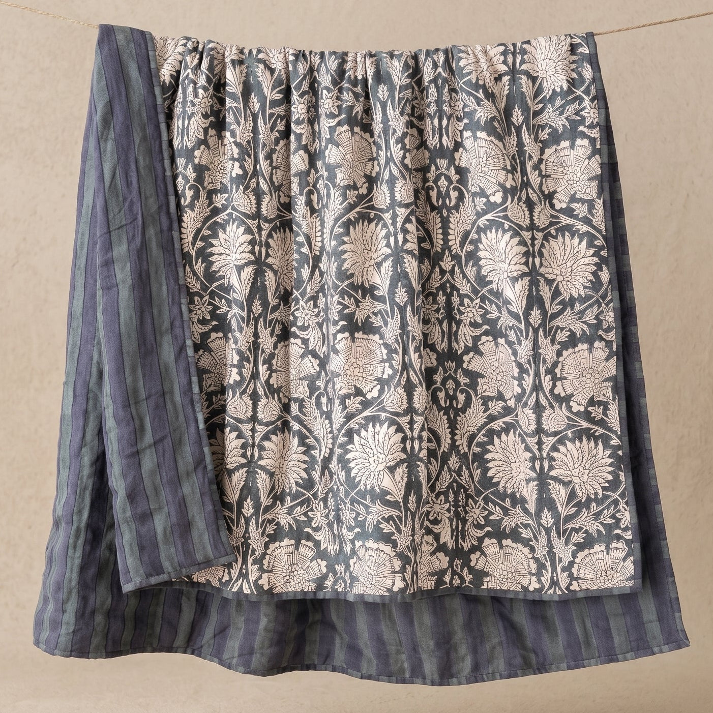 Ophelia hand-block printed linen quilt in indigo floral pattern on natural ground, US King size, draped to show full design, from WILLAGE