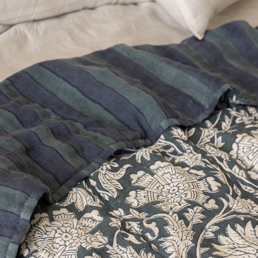 Detail of reversible side of Ophelia linen quilt showing hand-block printed indigo stripe pattern on European linen